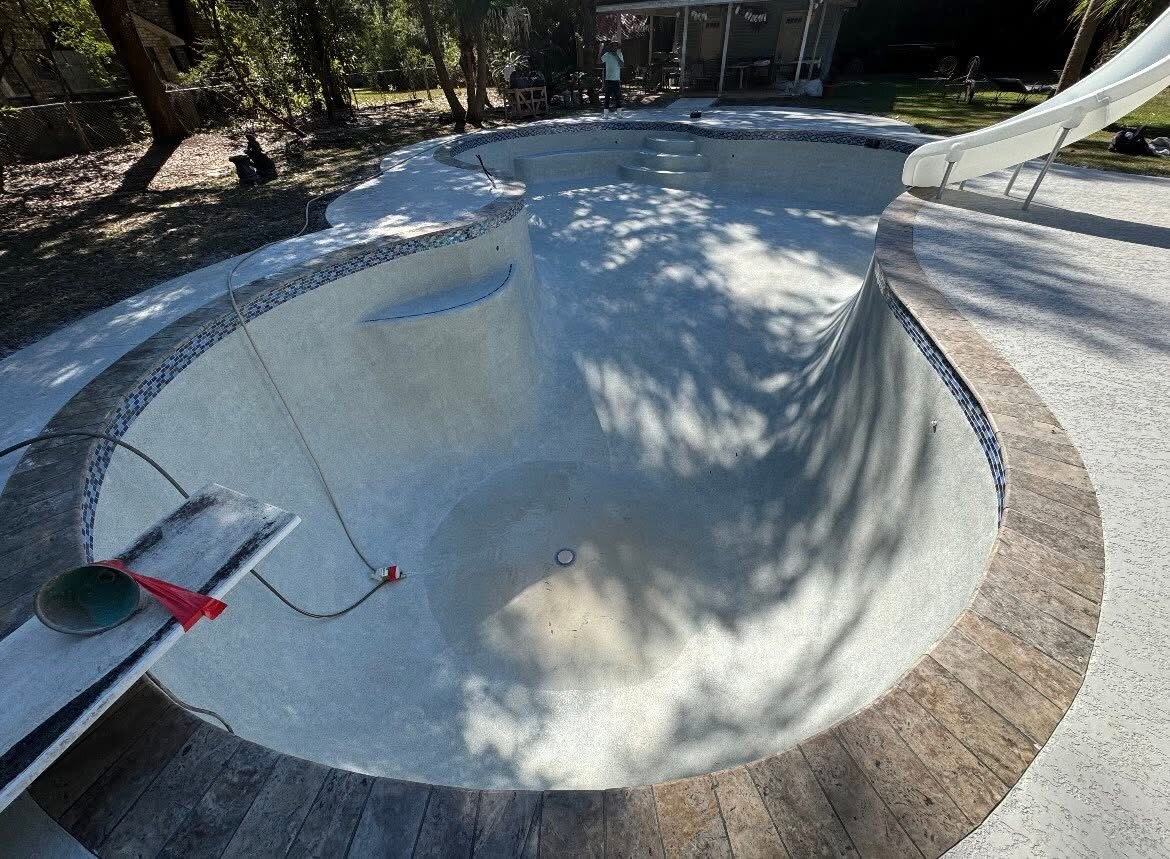 Pool interior renewed with a clean updated finish beside the restored deck