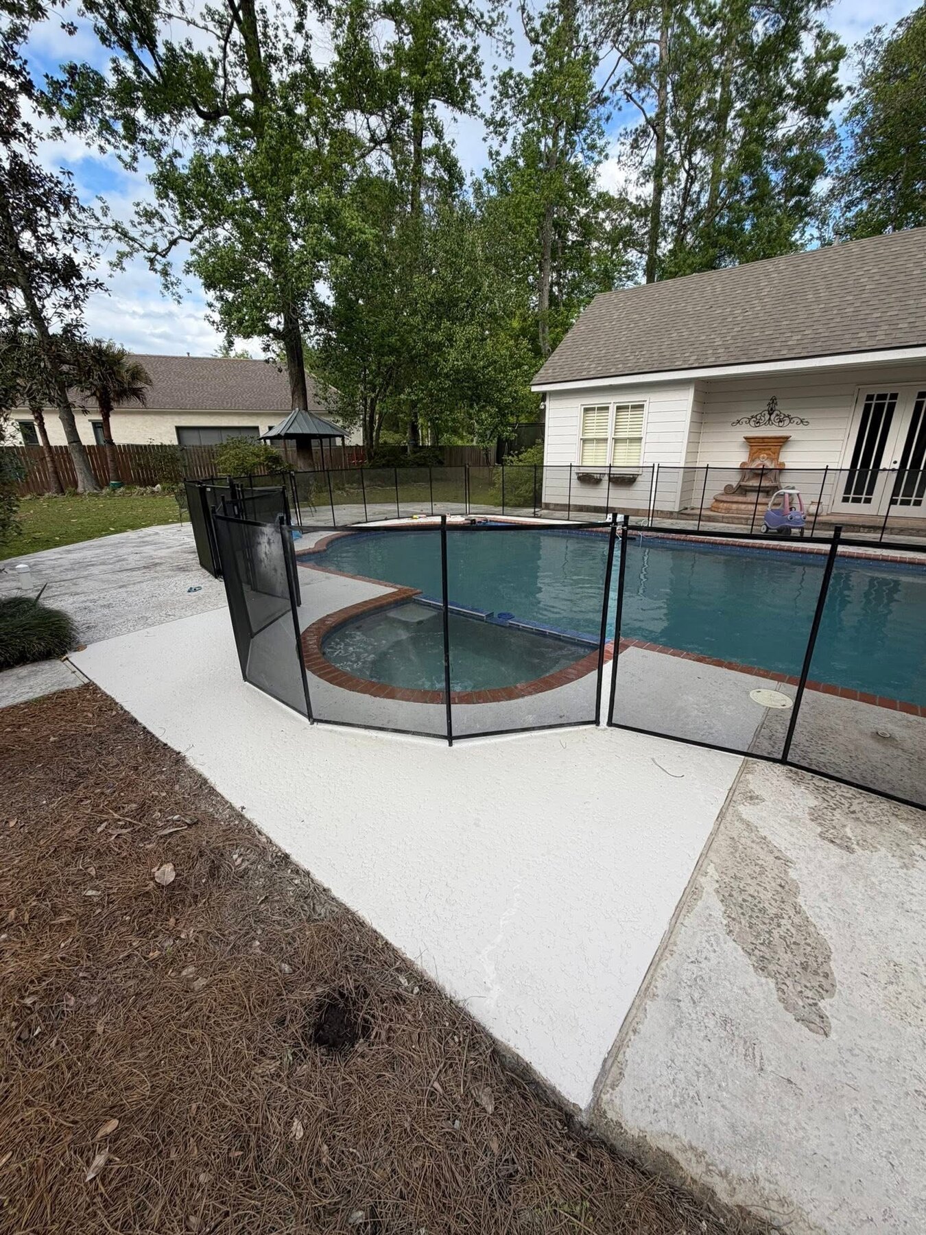 Finished pool and spa deck after concrete was re-poured and spray decking was applied