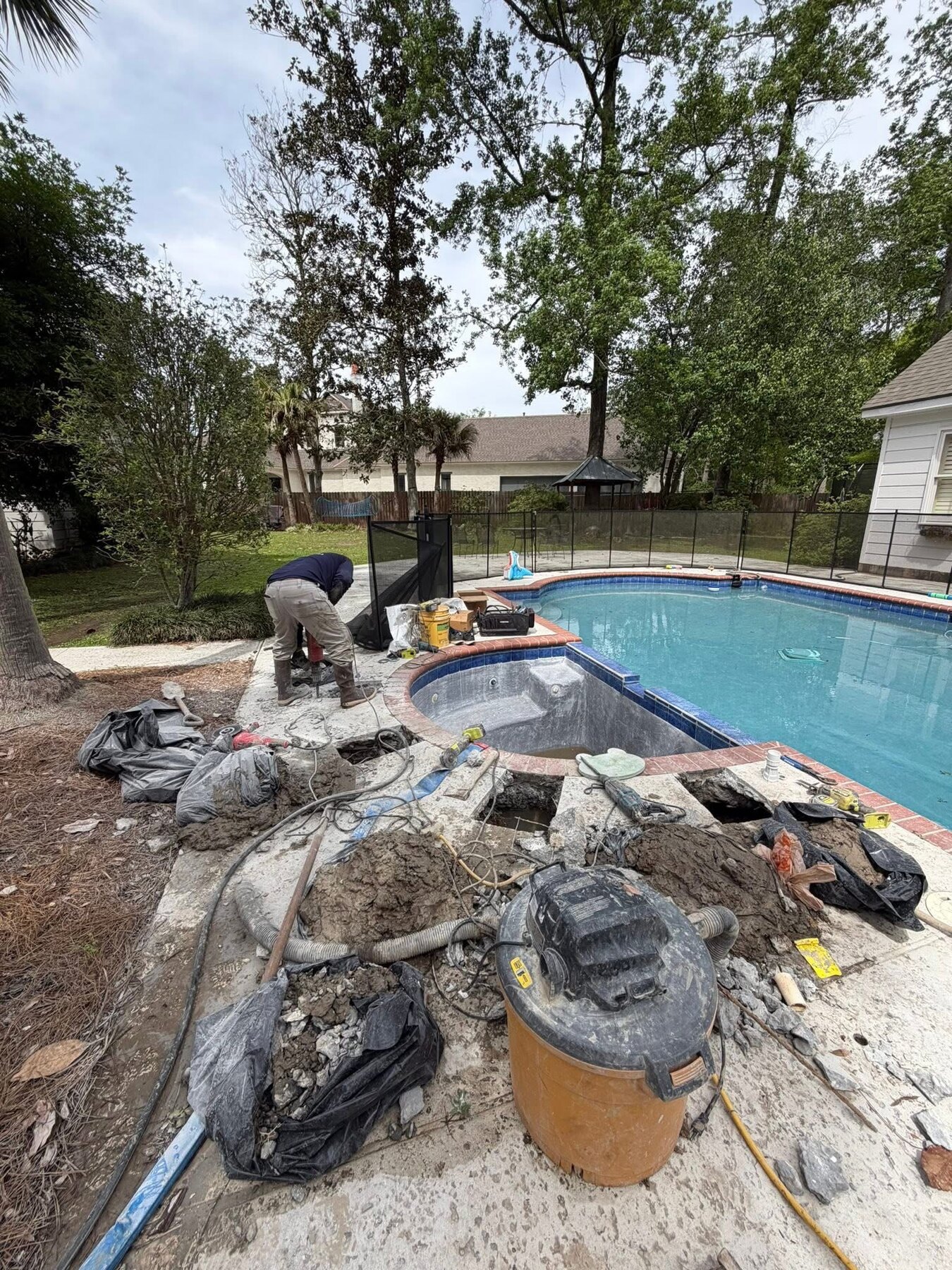 Pool deck opened at multiple points while three broken spa return lines are repaired