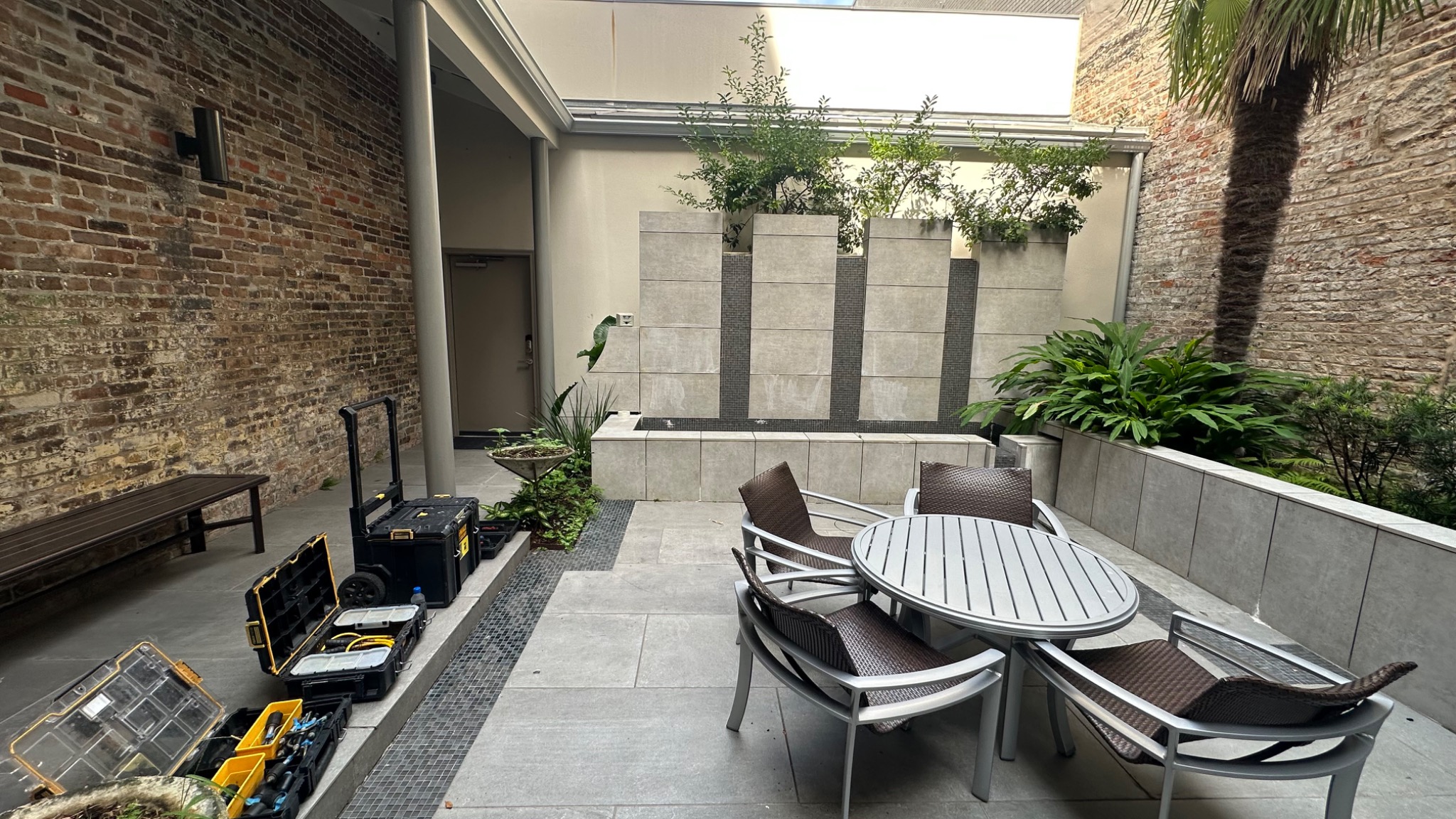 Leak-detection diagnostic equipment set up beside a courtyard water feature