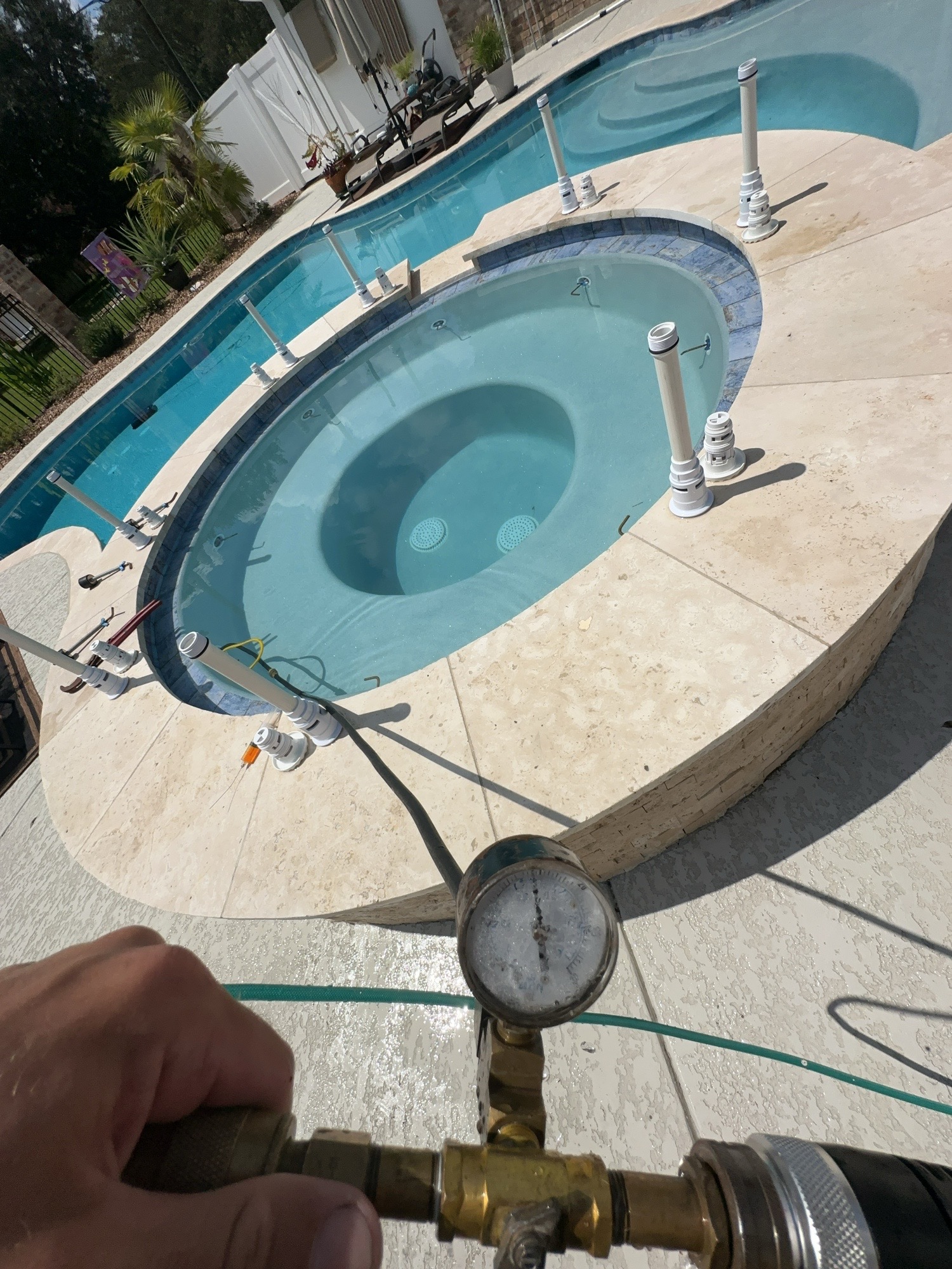 Pool and spa plumbing isolated for professional pressure testing with a pressure gauge